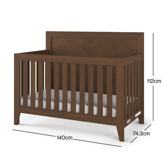 The Child Craft Kieran 4-in-1 Convertible Crib in Toasted Chestnut features vertical slats, a high headboard, and measures 140 cm long, 74.3 cm wide, and 112 cm high. The empty crib is displayed against a white background.