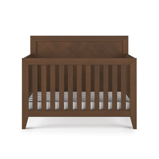 The Child Craft Kieran 4-in-1 Convertible Crib in Toasted Chestnut features a high, solid headboard and slatted sides, finished in a rich brown tone and displayed against a white background.