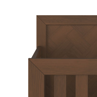 A close-up of the Child Craft Kieran 4-in-1 Convertible Crib in Toasted Chestnut, featuring a chevron-patterned back panel and vertical slats on the front, highlighting the smooth, dark brown wood grain.