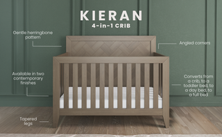 The Child Craft Kieran 4-in-1 Convertible Crib in Crescent Gray features a herringbone-patterned headboard, angled corners, tapered legs, and slatted sides, displayed against a green paneled wall with annotations on its finishes and features.