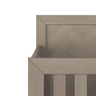 Close-up of the Kieran 4-in-1 Convertible Crib by Child Craft in Crescent Gray, featuring a herringbone back panel and vertical side slats that highlight its clean lines and modern design.