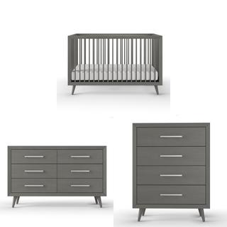 The Child Craft Cranbrook 4-in-1 Convertible Crib in Lunar Gray pairs with matching modern gray nursery pieces, including a six-drawer dresser and a tall four-drawer chest, all featuring silver handles and mid-century design.