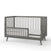 The Child Craft Cranbrook 4-in-1 Convertible Crib in Lunar Gray features slatted sides, angled legs, and a partial safety rail, bringing modern mid-century style to your nursery. Shown against a white background.