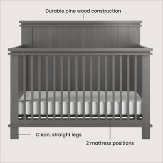 The Child Craft Denman 4-in-1 Convertible Crib in Midnight Gray features durable pine wood, a paneled headboard, clean straight legs, slatted sides, two mattress positions, and includes a white mattress.