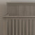 A close-up of the Child Craft Denman 4-in-1 Convertible Crib in Crescent Gray features vertical slats and a sturdy headboard, shown against a neutral wall.