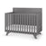 The Child Craft Soho 4-in-1 Flat Top Convertible Crib in Cool Gray features vertical slats, a solid back panel, and angled legs for a modern look. Shown with a white mattress, it's an ideal centerpiece for any nursery.