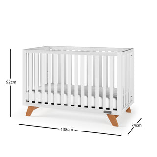 The Child Craft Soho 4-in-1 Convertible Crib in White/Natural features wooden legs, vertical slats on all sides, and includes a mattress. It measures 92 cm high, 138 cm long, and 74 cm wide.