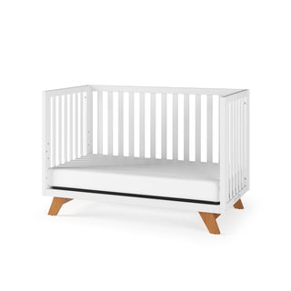 The Child Craft Soho 4-in-1 Convertible Crib in White/Natural comes with a matching white mattress.