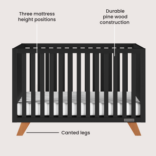 The Child Craft Soho 4-in-1 Convertible Crib in Ebony features mid-century modern design, pine wood construction, three mattress heights, and wooden canted legs. Text labels highlight each feature of this crib that converts to a toddler bed.