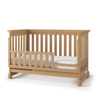 The Child Craft F09554 Toddler Guard Rail in Biscotti provides a safe, stylish partial rail for easy crib-to-toddler bed conversion—designed to fit your Child Craft crib seamlessly.