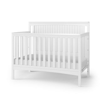 The Child Craft Scout 4-in-1 Convertible Crib in Matte White features slatted sides and a curved headboard, offering versatile nursery furniture perfect for your baby. Shown on a white background.