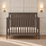 Child Craft Scout 4-in-1 Convertible Crib in Dapper Gray, featuring a wooden frame with vertical slats and a beadboard headboard.