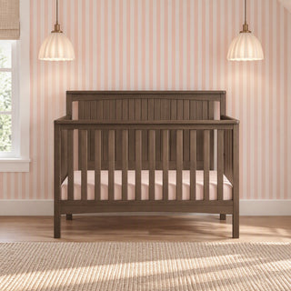 Child Craft Scout 4-in-1 Convertible Crib in Dapper Gray with a slatted design and a beadboard headboard.