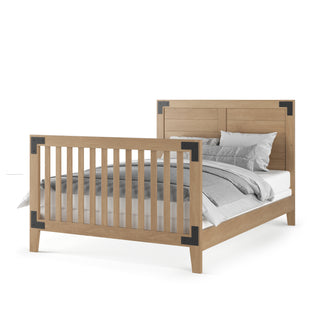The Child Craft F06464 Full-Size Bed Rail in Nutmeg features a wooden frame with a slatted footboard, solid headboard, and black metal accents. It’s designed to connect seamlessly with your Child Craft crib for easy transition to a full-size bed.