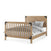 The Child Craft F06464 Full-Size Bed Rail in Nutmeg features a wooden frame with a slatted footboard, solid headboard, and black metal accents. It’s designed to connect seamlessly with your Child Craft crib for easy transition to a full-size bed.
