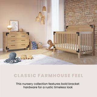 A cozy nursery with Child Craft’s Lucas 4-in-1 Convertible Crib in Nutmeg, wood furniture and black bracket hardware, a dresser, rocking horse, toys on a soft rug, pendant lights, and an exposed brick wall. Classic Farmhouse Feel.