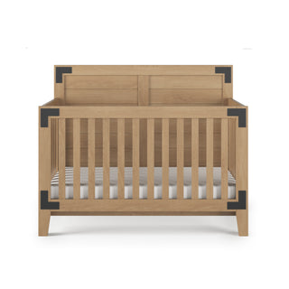 The Child Craft Lucas 4-in-1 Convertible Crib in Nutmeg features vertical slats, a solid panel headboard, and black corner brackets, displayed against a white background.