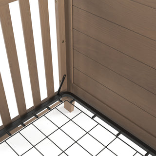 Close-up of the corner of the Child Craft Lucas 4-in-1 Convertible Crib in Dusty Heather, featuring vertical wooden slats, a wood-paneled side, and a black metal mattress support grid.