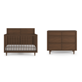 The Child Craft Surrey Hill 4-in-1 Convertible Crib in Toasted Chestnut, with vertical slats and modern angled legs, is paired with a matching six-drawer dresser, both displayed against a white background.