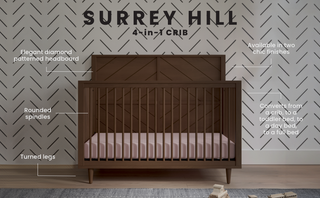 The Child Craft Surrey Hill 4-in-1 Convertible Crib in Toasted Chestnut features a diamond-patterned headboard, rounded spindles, and turned legs. Wall text notes its versatile design and two finishes. Geometric wallpaper adds a modern touch to the nursery.
