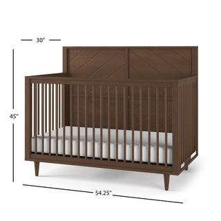 The Child Craft Surrey Hill 4-in-1 Convertible Crib in Toasted Chestnut features slatted sides, a solid headboard, measures 45"H x 30"D x 54.25"W, and is shown with a white mattress inside.