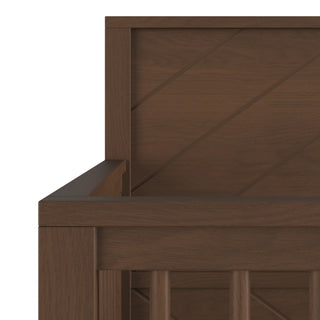 Close-up of the Child Craft Surrey Hill 4-in-1 Convertible Crib in Toasted Chestnut, showing its wooden crib corner with diagonal paneling on the headboard and vertical slats, all in a rich brown finish.