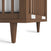 Close-up of the Surrey Hill 4-in-1 Convertible Crib by Child Craft in Toasted Chestnut, showing the bottom corner with vertical slats, angled legs, and two labels on the lower rail, set against a white background.