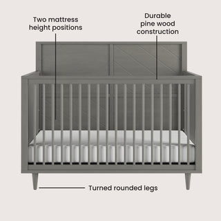 The Child Craft Surrey Hill 4-in-1 Convertible Crib in Lunar Gray features vertical slats, a paneled headboard, turned legs, two mattress height positions, and durable pine wood construction.