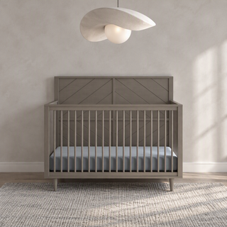 Lunar Gray Child Craft Surrey Hill 4-in-1 convertible crib with a paneled headboard and spindles.