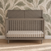 Lunar Gray Child Craft Surrey Hill 4-in-1 Convertible Crib with a diagonal-patterned headboard and vertical slats.