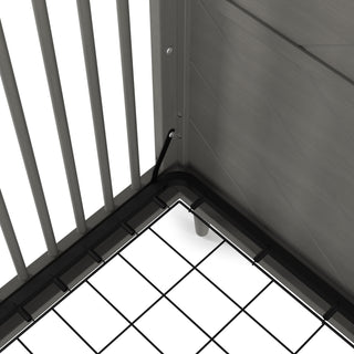 Close-up of the Child Craft Surrey Hill 4-in-1 Convertible Crib in Lunar Gray, showing the sturdy metal frame, vertical bars, mesh mattress support, and secure bolt, highlighting the crib's quality construction and thoughtful assembly.