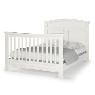 The Child Craft Westgate 4-in-1 Convertible Crib in Vintage Linen features a high headboard, matching footboard with vertical slats, adjustable mattress support, and comes neatly made with white and gray bedding.