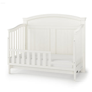 The Child Craft F09554 Toddler Guard Rail in Vintage Linen is shown against a white background, featuring a high curved headboard, side rails, and a partial crib guard rail for safe toddler bed conversion.