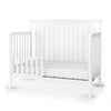 The Child Craft Toddler Guard Rail in Matte White features sturdy wood construction, an open slat design, partial guard rails on both sides, and a paneled headboard, shown against a plain white background.