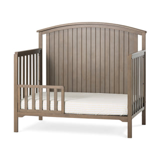 The Child Craft F09501 Toddler Guard Rail in Dusty Heather adds safety to your child's bed with vertical slats and a secure front rail. The arched, paneled headboard matches Child Craft cribs for easy conversion from crib to toddler bed.