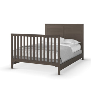A dark brown wooden bed frame with a paneled headboard, slatted footboard, white bedding, two pillows, and gray blanket. Modern, minimalist design pairs with Child Craft F06401 Full-Size Bed Rails in Matte White for versatility.
