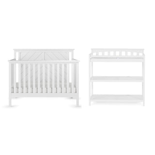 The Child Craft Hampton Flat Top 4-in-1 Convertible Crib in matte white with adjustable mattress support stands beside a matching white changing table with two shelves, both displayed against a plain background.