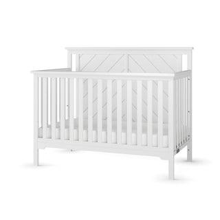 The Child Craft Hampton Flat Top 4-in-1 Convertible Crib in Matte White features solid pine construction, vertical slats, a high back panel, and adjustable mattress support. Simple, modern design shown against a plain white background.