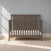 Hampton Flat Top 4-in-1 Convertible Crib in Dapper Gray with a flat top and a paneled headboard featuring a chevron design.