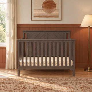 Dapper Gray Child Craft Hampton Flat Top 4-in-1 Convertible Crib featuring a flat top and X-patterned headboard.