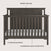 The Child Craft Hampton Flat Top 4-in-1 Convertible Crib in Dapper Gray features a modern flat top, slatted sides, solid chevron back panel, three adjustable mattress positions, and durable pine wood construction.