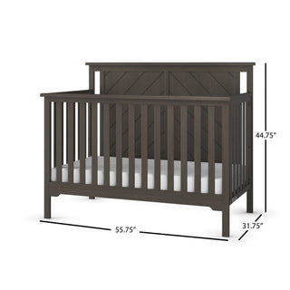 The Child Craft Hampton Flat Top 4-in-1 Convertible Crib in Dapper Gray features a slatted design, solid headboard, and includes a white mattress. Dimensions: 44.75" H x 55.75" W x 31.75" D.