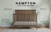 The Child Craft Hampton Flat Top 4-in-1 Convertible Crib in Dusty Heather stands out with its chevron-patterned headboard, stylish design, flat top, and three rustic finishes, shown here against star-patterned wallpaper.