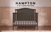 The Child Craft Hampton Arch Top 4-in-1 Convertible Crib in Dapper Grey features vertical shiplap paneling, an arched headboard, adjustable mattress support, three finishes, and a versatile convertible design.