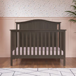 Child Craft Hampton Arch Top 4-in-1 Convertible Crib in Dapper Grey, featuring a slatted design and an arched headboard.