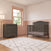 A grey Hampton Arch Top 4-in-1 Convertible Crib by Child Craft and a matching three-drawer dresser in a nursery with pink wainscoting and terrazzo-patterned wallpaper.