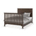 The Child Craft F06401 Full-Size Bed Rails in Brushed Truffle support a dark brown wooden bed frame with vertical slats on the headboard and footboard, neatly made with white and gray bedding and pillows.