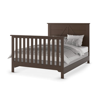 A Child Craft Woodland 3-Piece Nursery Set in dark wood features a crib with vertical slats and white and gray bedding, displayed at an angle against a plain white background.