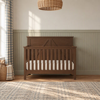 Child Craft Woodland 4-in-1 Convertible Crib in Brushed Truffle with a farmhouse-style headboard featuring a horizontal cross-brace detail and adjustable mattress support.