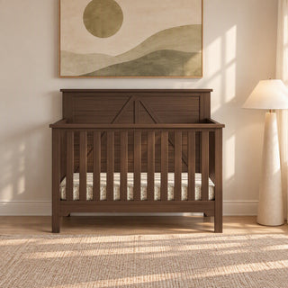 A dark pine Child Craft Woodland 4-in-1 Convertible Crib in Brushed Truffle with a slatted design, a decorative X-brace on the headboard, and adjustable mattress support.